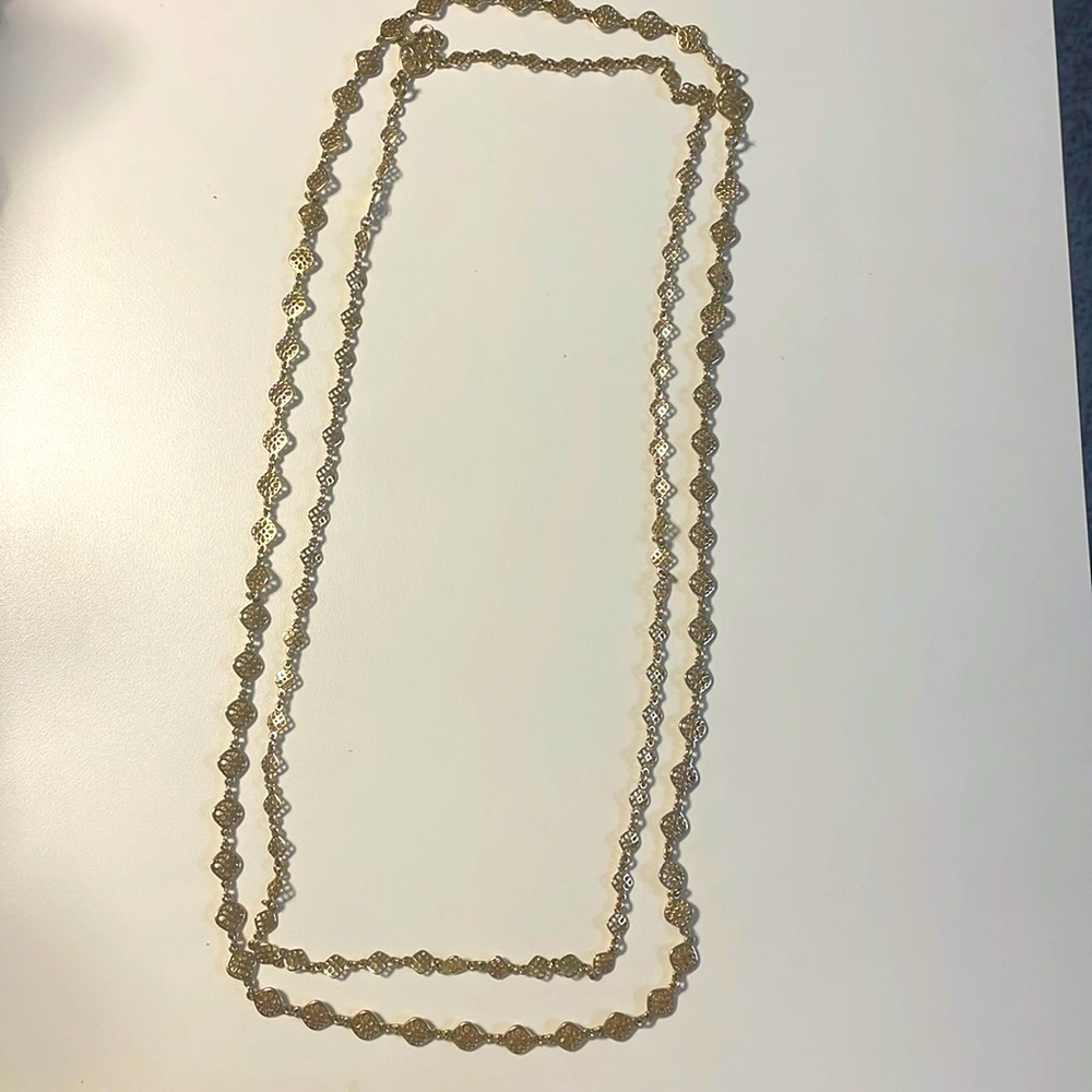 Sella and dot double gold necklace.